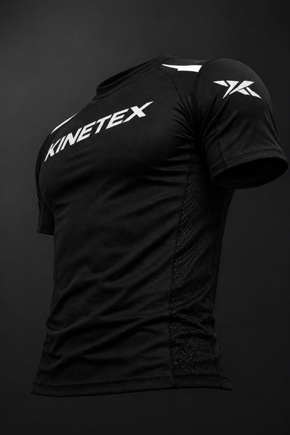 Kinetex black short-sleeve compression rash guard with white Kinetex logo on chest and shoulder.
