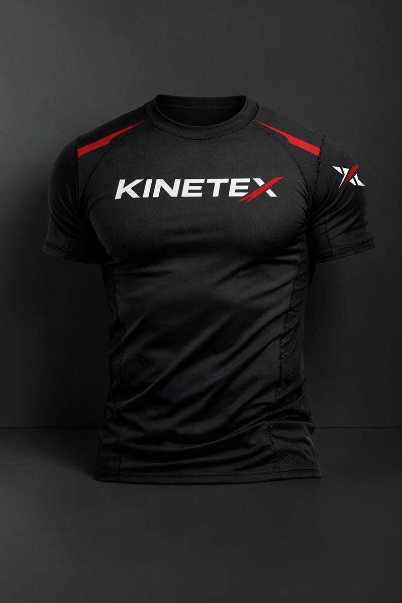 Kinetex black short-sleeve compression rash guard with red accents and white logo, designed for athletic performance.