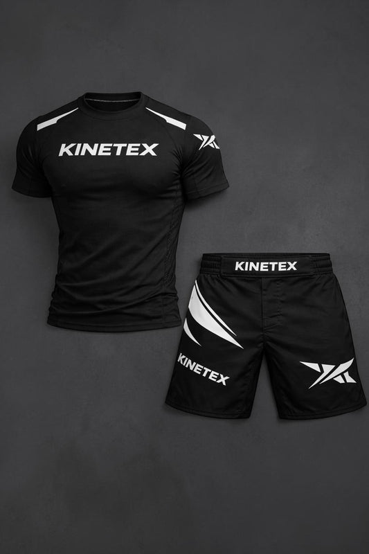 Kinetex black MMA combat pro set with compression rash guard and shorts featuring white Kinetex branding and graphic accents.