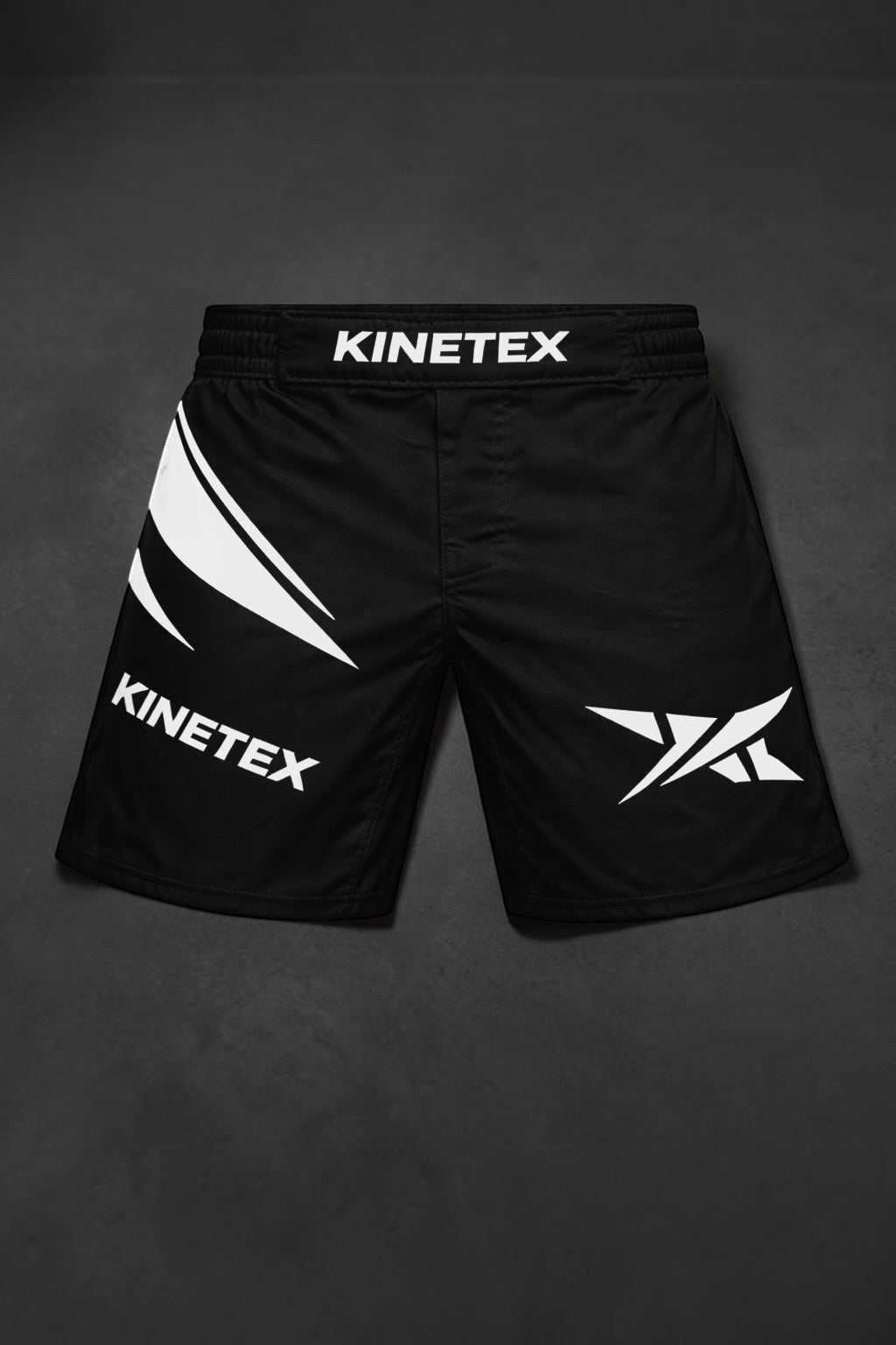 Kinetex black MMA combat shorts with white graphic accents and logo, designed for performance and mobility.