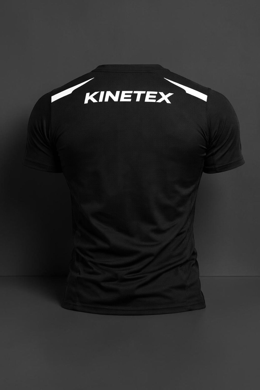 Kinetex black performance compression rash guard with white Kinetex logo on back and white accents on shoulders.
