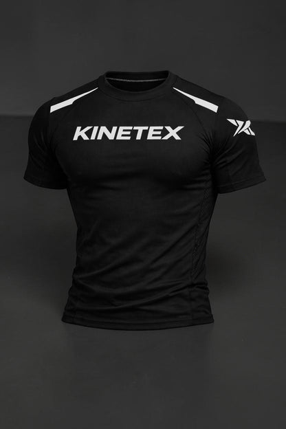 Kinetex black performance compression rash guard with white Kinetex logo on chest and white accents on shoulders.