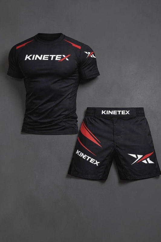 Kinetex black MMA compression rash guard with red accents and white logo, paired with black MMA shorts with red accents and Kinetex branding.