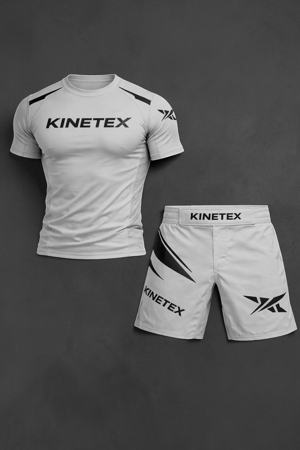 Kinetex light grey MMA compression rash guard and combat shorts set with black branding and accents.